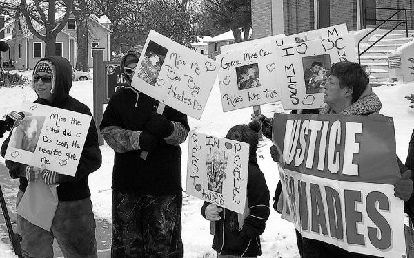 About 10 people gathered outside the Marshall County Courthouse for about two hours Friday to protest the police shooting of pet pit bull in Toluca. At far left is dog-owner Heather Graham of Toluca, and at far right with the Justice for Hades sign is Marsha Soto of Peoria, a pit bull owner and activist.