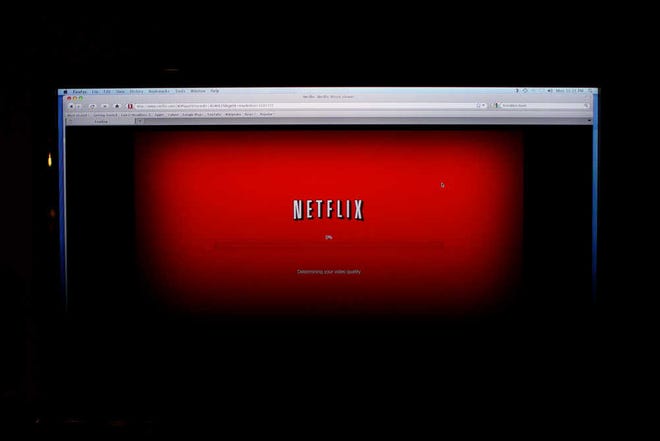 FILE - In this Monday, Nov. 22, 2010, file photo, a movie selected from among Netflix's "Watch Instantly" titles begins to download on a home computer screen in New York. Netflix is testing new price plans for streaming video as it tries to lure more viewers. (AP Photo/James H. Collins, File)
