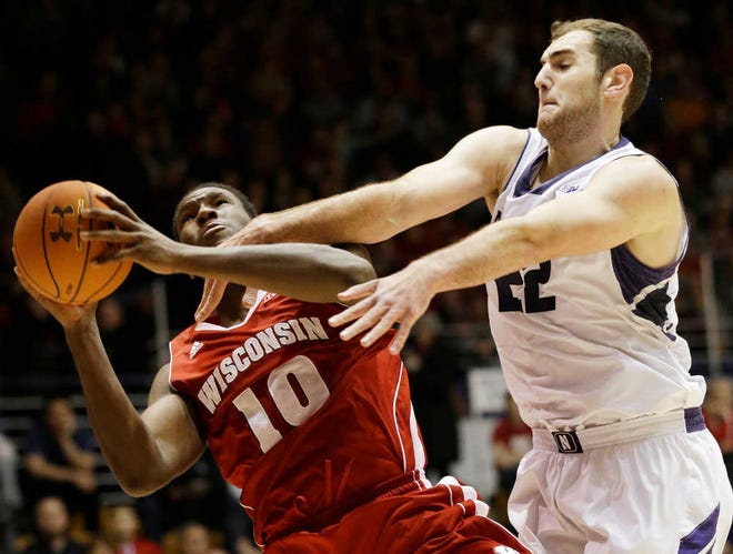 Wisconsin forward Nigel Hayes, left, shoots against Northwestern center Alex Olah during the first half of an NCAA college basketball game in Evanston, Ill., on Thursday, Jan. 2, 2014. (AP Photo/Nam Y. Huh)