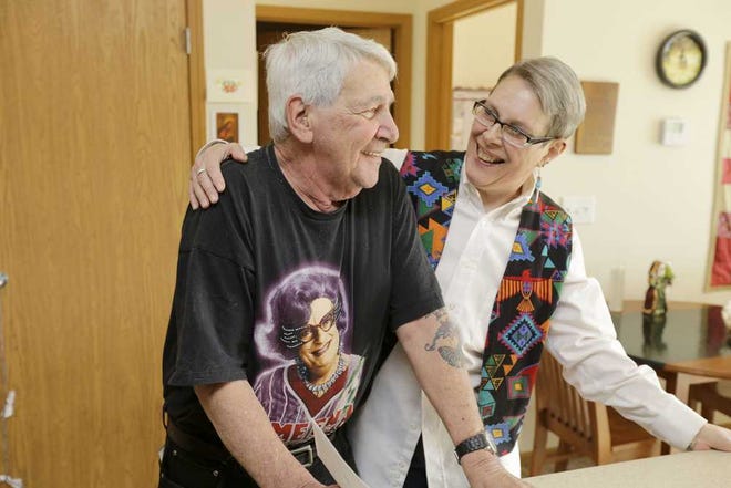 In this Dec. 12, 2013 photo, Harvey Hertz, left, poses with Lucretia Kirby, right, in Kirby's unit at Spirit on Lake, an affordable housing complex marketed to older members of the gay, lesbian, bisexual and transgender community, in Minneapolis, Minn. (AP Photo/Ann Heisenfelt)