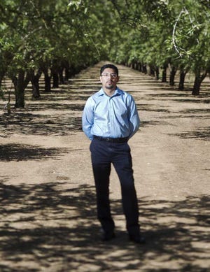 In this photo taken on June 29, 2012, Sergio Garcia poses for a photo an almond orchard in Durham, Calif., similar to one he used to work at. The California Supreme Court granted a law license on Thursday, Jan. 2, 2014, to Garcia, who is living in the United States illegally. Garcia, who graduated from law school and passed the state bar exam, can begin practicing law despite his immigration status. He arrived in the U.S. illegally 20 years ago to pick almonds with his father. (AP Photo/San Jose Mercury News, Patrick Tehan) MAGS OUT; NO SALES