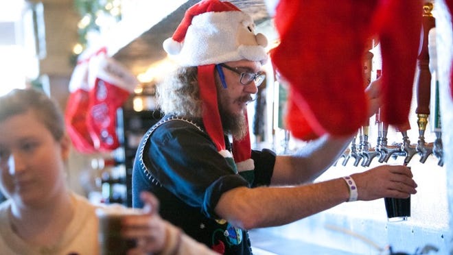 Bartender Ben Kazda works at the Dig Pub in Austin on Dec. 16. The Texas service sector had a strong month in December, according to a report from the Federal Reserve Bank of Dallas.Photo credit: Julia Robinson/ FOR AMERICAN-STATESMAN;