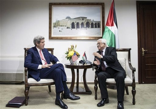 U.S. Secretary of State John Kerry, left, and Palestinian President Mahmoud Abbas talk before a meeting at the presidential compound in the West Bank city of Ramallah, Friday, Jan. 3, 2014. Kerry took the tenth trip to the region to negotiate a peace deal he claims is "not mission impossible."