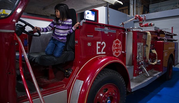 Madelyn Yem, 5, plays on the fire engine Thursday at the Children's Museum in downtown Stockton.