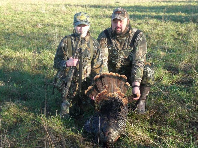 Tanya Gehring, of Olpe, is a past winner of the Flint Hills Gobbler's essay contest. She is pictured with her father, Matt. Her guide, Gib Rhodes, said the jake was a very large bird for its age, with short spurs and two short beards.