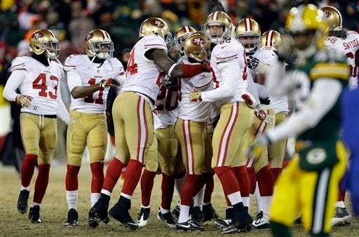 San Francisco 49ers players celebrates after San Francisco 49ers kicker Phil Dawson (9) kicks the game winning field goal during the second half of an NFL wild-card playoff football game, Sunday, Jan. 5, 2014, in Green Bay, Wis. The 49ers won 23-20. (AP Photo/Mike Roemer)