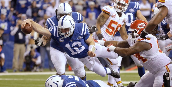 Indianapolis Colts quarterback Andrew Luck (12) dives for a touchdown after recovering a fumble by the Colts' Eric Berry during the second half of an NFL wild-card playoff football game against the Kansas City Chiefs Saturday, Jan. 4, 2014, in Indianapolis.