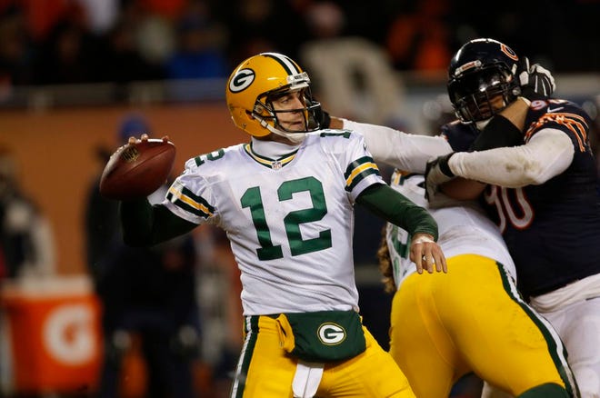 Green Bay Packers quarterback Aaron Rodgers (12) throws a pass during the second half of an NFL football game against the Chicago Bears, Sunday, Dec. 29, 2013, in Chicago. (AP Photo/Charles Rex Arbogast)