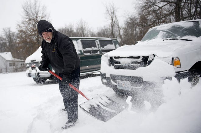 David Swafford clears snow from his driveway Sunday on Worley Street. A storm system dropped several inches of snow over a large swath of Missouri starting Saturday night into yesterday, followed by an extreme drop in temperatures and dangerous wind chills.
