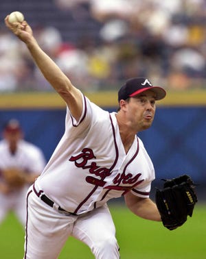 FILE - In this Sept. 22, 2002, file photo, Atlanta Braves starting pitcher Greg Maddux delivers to a Florida Marlins batter in the first inning of a baseball game at Turner Field in Atlanta. Mad Dog and Glav were fixtures in the Atlanta Braves rotation for years, and now they await word on another possible honor that will keep them together: induction into the Baseball Hall of Fame. (AP Photo/Erik S. Lesser, File)