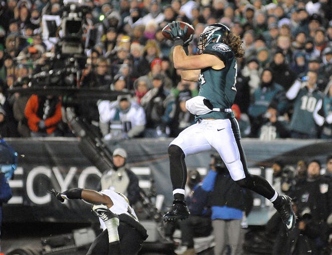 Riley Cooper (14) catches a touchdown pass from quarterback Nick Foles during the Eagles vs. Saints game at Lincoln Financial Field on Saturday night.