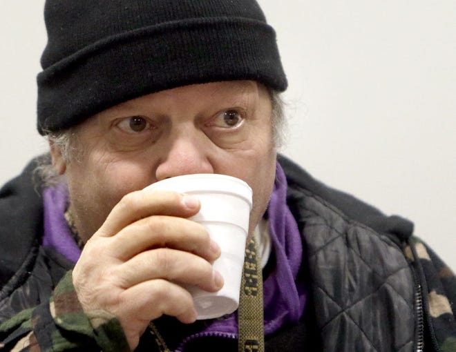 Daniel Guido takes advantage of a hot cup of coffee at the Red Cross warming station at the Community Complex inside Goodwill at 408 9th St SW. It will remain open today until 9 p.m. and open again Wednesday 9 a.m.-9 plm.