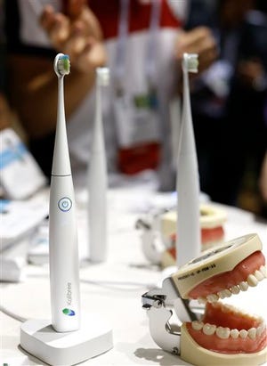 The Kolibree toothbrush sits on display at the International Consumer Electronics Show, Sunday, Jan. 5, 2014, in Las Vegas. Using Bluetooth wireless, the toothbrush senses how it’s moved and can send the information to an Android phone or iPhone and will be able to teach you to brush right and long enough.
