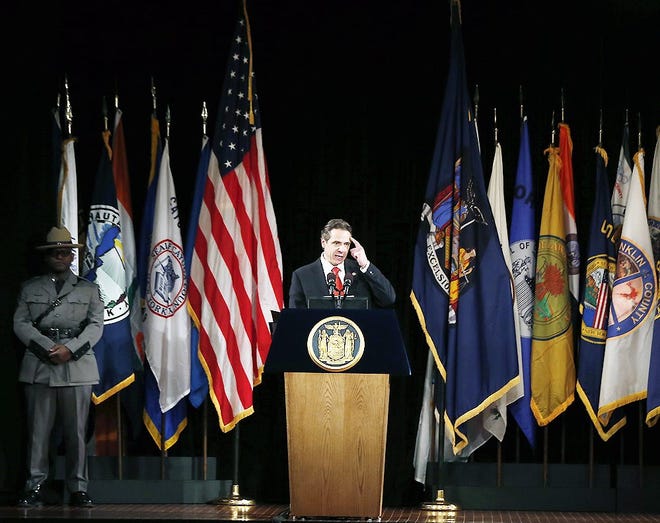 New York Gov. Andrew Cuomo delivers his annual State of the State address at the Empire State Plaza Convention Center on Wednesday in Albany. AP PHOTO/MIKE GROLL
