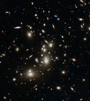 This undated image made available by the European Space Agency and NASA on Tuesday, Jan. 7, 2014 shows galaxies in the Abell 2744 cluster, and blue galaxies behind it, distorted and amplified by gravitational lensing. The long-exposure image taken with NASA's Hubble Space Telescope shows some of the intrinsically faintest and youngest galaxies ever detected in visible light. (AP Photo/ESA/NASA)