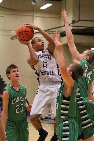 Monmouth-Roseville junior James Rogers makes a move to the hoop at the Macomb-Western Holiday Tournament. SAM MARLOW.