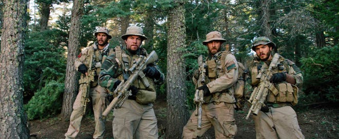 This photo released by Universal Pictures shows, from left, Taylor Kitsch, as Michael Murphy, Mark Wahlberg as Marcus Luttrell, Ben Foster as Matt "Axe" Axelson, and Emile Hirsch as Danny Dietz in a scene from the film, "Lone Survivor." In the age of the superhero, the movies' most reliable real-life hero has been the Navy SEAL. "Lone Survivor," is the latest in a string of films, including "Zero Dark Thirty" and "Act of Valor" to honor the Navy's special operations force with as much faithfulness as the filmmakers could muster. (AP Photo/Universal Pictures)