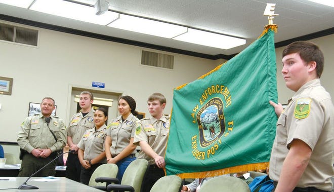 From left, Siskiyou County Sheriff's Deputy Bob Buker, Explorers sergeant Aaron Jacobson, sergeant Angel Cabrera, Lauryn Strickland, Mitchell Gould and Aaron Winningham present the Siskiyou Explorers' new post flag.