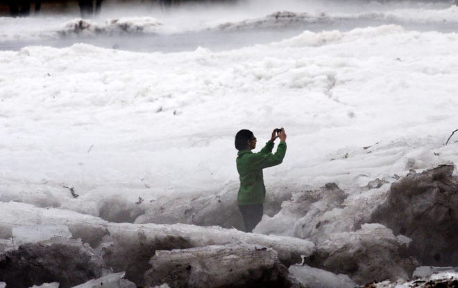 Sonali Deliwala of Yardley photographs the ice in the Delaware River in Lower Makefield Saturday.