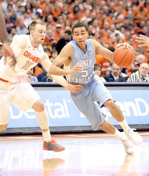 North Carolina's Marcus Paige (right) drives past Syracuse's Trevor Cooney in the first half Saturday at the Carrier Dome.



AP Photo/Nick Lisi