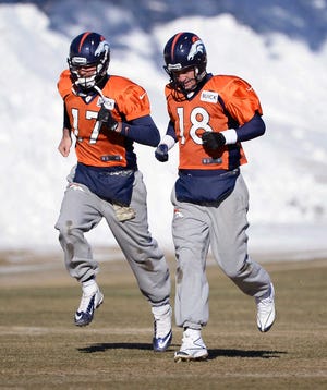 Denver Broncos quarterback Peyton Manning (18) and Denver Broncos quarterback Brock Osweiler (17) head to drills during practice at Dove Valley as they prepare for an NFL football game against the San Diego Chargers in the Divisional Round of the Playoffs on Jan. 6, 2014, in Englewood, Colo. (AP Photo/The Denver Post, John Leyba) MAGS OUT; TV OUT; INTERNET OUT; NO SALES; NEW YORK POST OUT; NEW YORK DAILY NEWS OUT