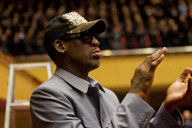 Dennis Rodman applauds from court side at an exhibition basketball game between U.S. and North Korean players at an indoor stadium in Pyongyang, North Korea on Wednesday, Jan. 8, 2014. (AP Photo/Kim Kwang Hyon)