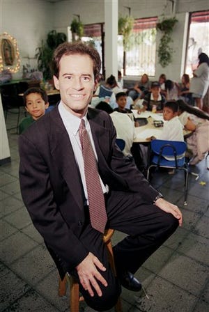 FILE - In this Aug. 27, 1997 file photo, Ron Unz, poses inside the Las Families Del Pueblo child care center in Los Angeles. Unz, a Silicon Valley multimillionaire and registered Republican who once ran for governor and, briefly, U.S. Senate, wants state voters to endorse the wage jump that he predicts would nourish the economy and lift low-paid workers from dependency on food stamps and other assistance bankrolled by taxpayers. Two decades ago, Unz tried to unseat then-Gov. Pete Wilson, a fellow Republican. After a long break on the political sidelines, Unz’s reappearance has startled members of both major parties, and his proposal, if it goes to voters in November, could unsettle races from governor to Congress.