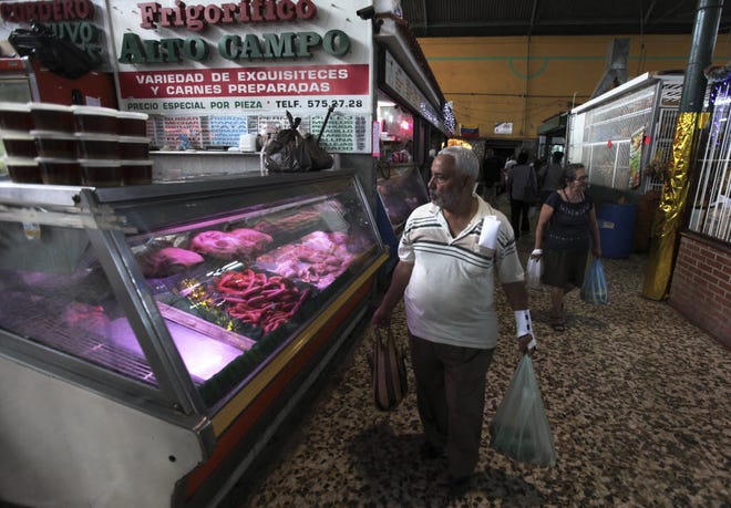 Customers shop in a food market in Caracas, Venezuela, in December 2011. Inflation that year was a massive 27 percent – a figure dwarfed by last year's 56.2 percent jump in consumer prices.