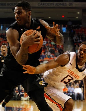 Torren Jones (24) pulls in a loose ball as Auburn’s Tahj Shamsid-Deen (13) attempts to get his hands on it during Missouri’s 70-68 victory Saturday in Auburn, Ala. MU got a big boost off the bench from Jones, who pulled down a career-high 11 rebounds and hit four first-half free throws.