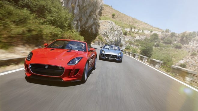 Two 2014 F-Types, an all-new, two-seater Jaguar sports car, debut at the Paris Motor Show. In front is the V8 version; in back, the V6. Courtesy of Jaguar
