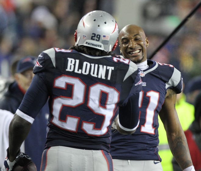 Ex-Buccaneers LaGarrette Blount celebrates with teammate Aqib Talib after Blount ran for a 73-yard touchdown, leading the Patriots to a 43-22 win over the Colts on Saturday.