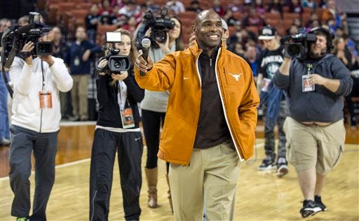 Texas new head football coach Charlie Strong speaks to fans during a timeout against Oklahoma in the first half of an NCAA college basketball game in Austin, Texas, Wednesday, Jan. 8, 2014.