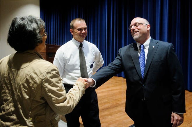 Janet Wright, left, a member of the Columbia College Board of Trustees, shakes hands Monday with Scott Dalrymple, dean of the School of Liberal Arts at Excelsior College in Albany, N.Y., as Columbia College controller Allen Schelp watches. Dalrymple, a finalist in the college’s presidential search, answered questions during a community forum Monday morning.