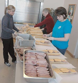 Perennial Park Senior Center employees and volunteers work on making submarine sandwiches for last year's Super Bowl Sub Sandwich fundraiser. Sandwiches are once again on sale this year for $7 a piece. Orders will be taken through Jan. 27.