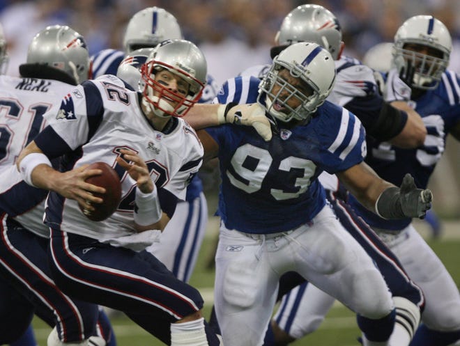 Patriots quarterback Tom Brady, who is no stranger to being viewed as an underdog, tries to escape the clutches of the Colts’ Dwight Freeney during the AFC Championship Game on Jan. 21, 2007. The Pats lost that game, 38-34.