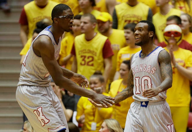 Kansas' Joel Embiid, left, and Naadir Tharpe missed a total of three shots in the Jayhawks' 77-70 victory over Iowa State on Monday night in Ames, Iowa. The duo combined to hit 14 of 17 field goals and finished with 16 and 23 points, respectively. Andrew Wiggins added 17 points and 19 boards.
