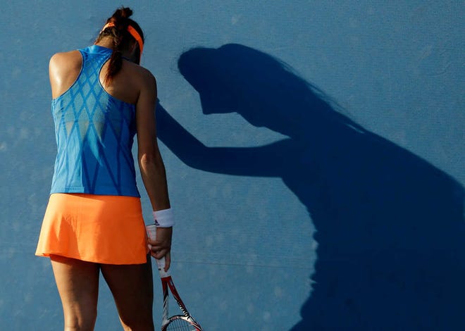 Sorana Cirstea of Romania rests on the back of the court during her first round match against Marina Erakovic of New Zealand at the Australian Open tennis championship in Melbourne, Australia, Tuesday, Jan. 14, 2014. (AP Photo/Aijaz Rahi)