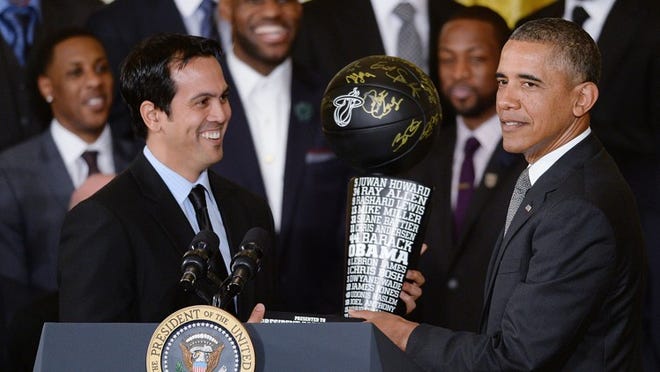 U.S. President Barack Obama receives a trophy from head coach Erik Spoelstra as Obama welcomes the 2013 NBA Champion Miami Heat to the White House on Tuesday, Jan. 14, 2014, in Washington, DC. (Olivier Douiery/Abaca Press/MCT)