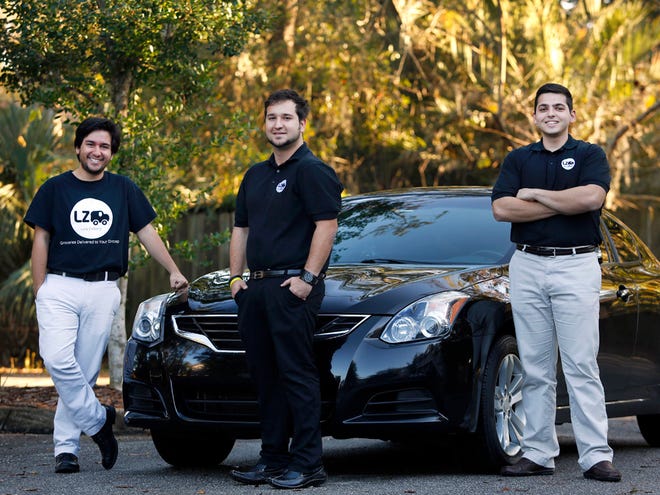 Co-founders of Lazy Delivery, left to right, Daniel Zelaya, Manuel Zelaya and Marc Charbel are shown with one of their cars used to deliver items to customers in Gainesville.