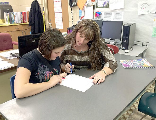 Litchfield Schools middle school/high school and fifth grade teacher Kristen Miller works with Abbigayle McCafferty during the school day.