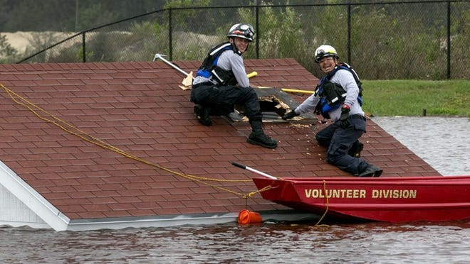 A Florida Task Force 1 search team locates survivors in a flooded home during a training exercise at the Palm Beach County Fire Rescue Regional Training Center on Pike Road in West Palm Beach, Florida on January 9, 2014. Palm Beach County Fire Rescue is hosting a full scale USAR training exercise involving rescue teams from across the state including the Federal FEMA USAR teams from Miami. (Allen Eyestone/The Palm Beach Post)