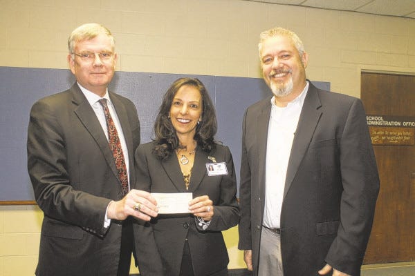 SPECTATOR PHOTO BY GEORGE AUSTIN
The Somerset Insurance Underwriters Association presented a grant for $3,500 to Somerset Middle School last week so that user fees do not have to be charged to students to play on the baseball and softball teams there. From left to right are Brian Murphy, incoming president of the association, Principal Pauline Camara and Richard Paquin, immediate past president of the association.