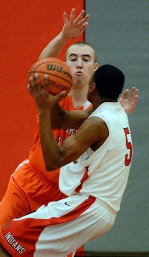 Cherokee's 13 Kyle Kahriger gets in the face of Lenape's 5 Kelsey Gray as he tries to shoot during second quarter action, Thursday night.