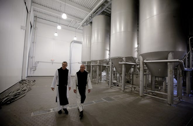 Brewery director Father Isaac, above right, and Father Damion, abbot, walk through the new brewing facility at St. Joseph's Abbey in Spencer.