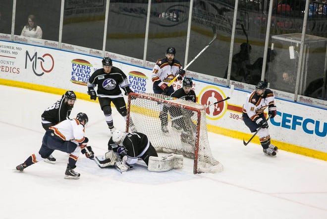 Rivermen center Nick Prockow reaches for the puck under goaltender B.J. O'Brien's glove while Peoria linemates Justin Gvora (78) and Taylor Larsen (11) look on during Peoria's 2-0 victory over Bloomington in an SPHL game Friday at U.S. Cellular Coliseum.