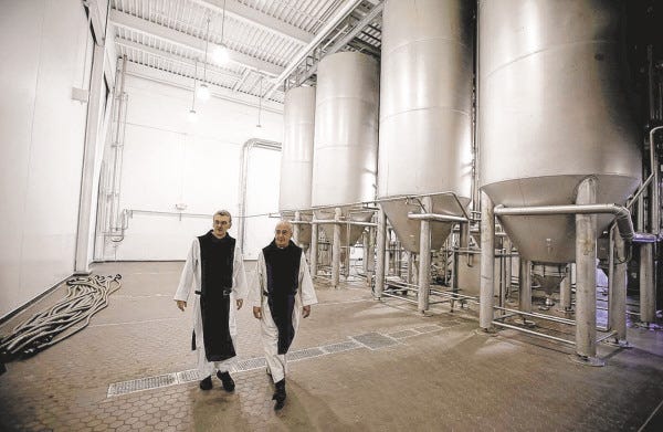 Father Damion, abbot at St. Joseph's Trappist Abbey, left, and Spencer Brewery director Father Isaac walk through their new, state-of-the-art facility in Spencer, Mass.