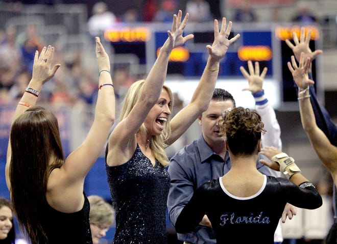 Florida coach Rhonda Faehn congratulates Kytra Hunter after her vault against the Minnesota Gophers on March 1. The score for the Gators was a school record.