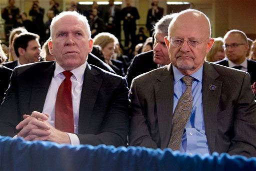 Director of National Intelligence James Clapper, right, and CIA Director John Brennan, left, sit in the front row before President Barack Obama spoke about National Security Agency (NSA) surveillance, Friday, Jan. 17, 2014, at the Justice Department in Washington. The president called for ending the government's control of phone data from millions of Americans. (AP Photo/Carolyn Kaster)