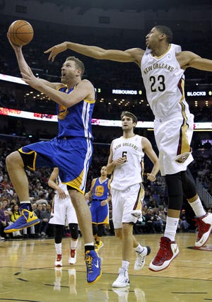 Golden State's David Lee (left) drives to the basket as New Orleans' Anthony Davis (23) defends during Saturday's game.