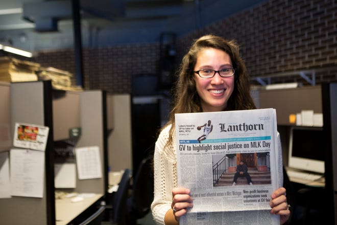 The Lanthorn's Editor-in-Chief, Lizzy Balboa, holds a copy of the paper in the newsroom in the Kirkhof Center at Grand Valley State University on Friday, Jan. 17, 2014. The student-run newspaper has caused a stir on campus after questioning the university's policy of naming rooms and buildings after donors. (AP Photo/ MLive.com, Lauren Petracca)